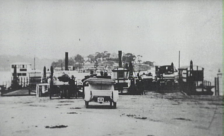 Steam punt loaded with automobiles approaching Tom Ugly's Point, 1910.