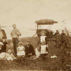 Picnic party at Cronulla Beach with cart in backgound