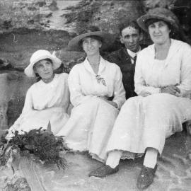 Picnic group sitting on rock at Jibbon Beach, ca. 1918