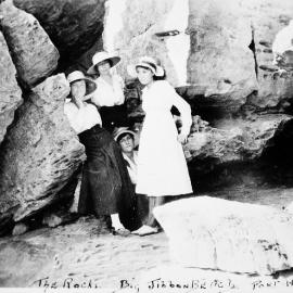 Group of four women at the rocks on Jibbon Beach,ca. 1918