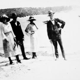 Five people standing on the sand at Jibbon Beach, ca. 1918