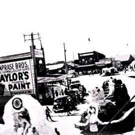 Procession of decorated floats through Cronulla shopping centre, ca. 1930s or 1940s