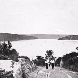 Port Hacking with people and dogs on the road and view of the water, ca. 1920s