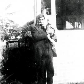 Grandfather Henry James Richards, with baby, outside house, ca. 1925
