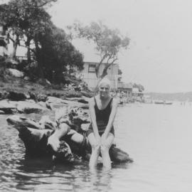 Jo sitting on a tree stump, Gunnamatta Bay, 1935