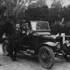 High-sided automobile with passengers and man astride horse on the Saville Creek Bridge, ca. 1927