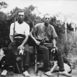 Stan Bentley of Menai and friend Sam Innes with dogs and shooting rifles, ca. 1900s