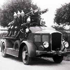 Members of the Sutherland fire brigade driving along in a fire engine