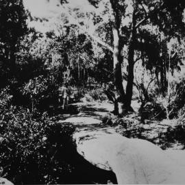 Natural stone bridge at North West Arm, view with man in background, ca. mid 1920s