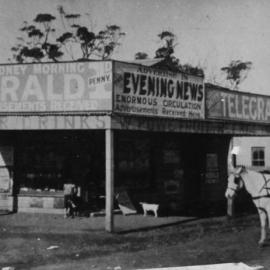 Newsagency on the corner of Princes Highway and Boyle Street, Sutherland, with first council chambers building background right, ca. early 1900s