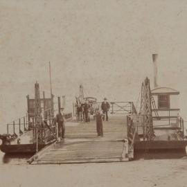 Steam ferry at landing wharf with Captain J. McClenahan at left, ca. early 1900s