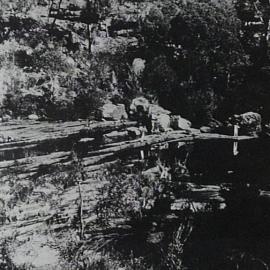 Frank Cridland and companion shooting mullet with rifle bullets at the old Illawarra Road ford over Woronora River, ca. 1920s