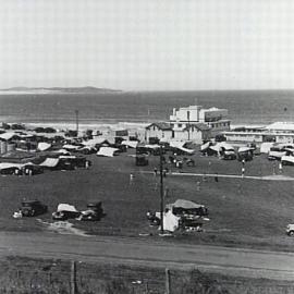 Cronulla Beach North looking east, with view of Dunningham Park, surf clubhouse and beach shop, ca. 1937.